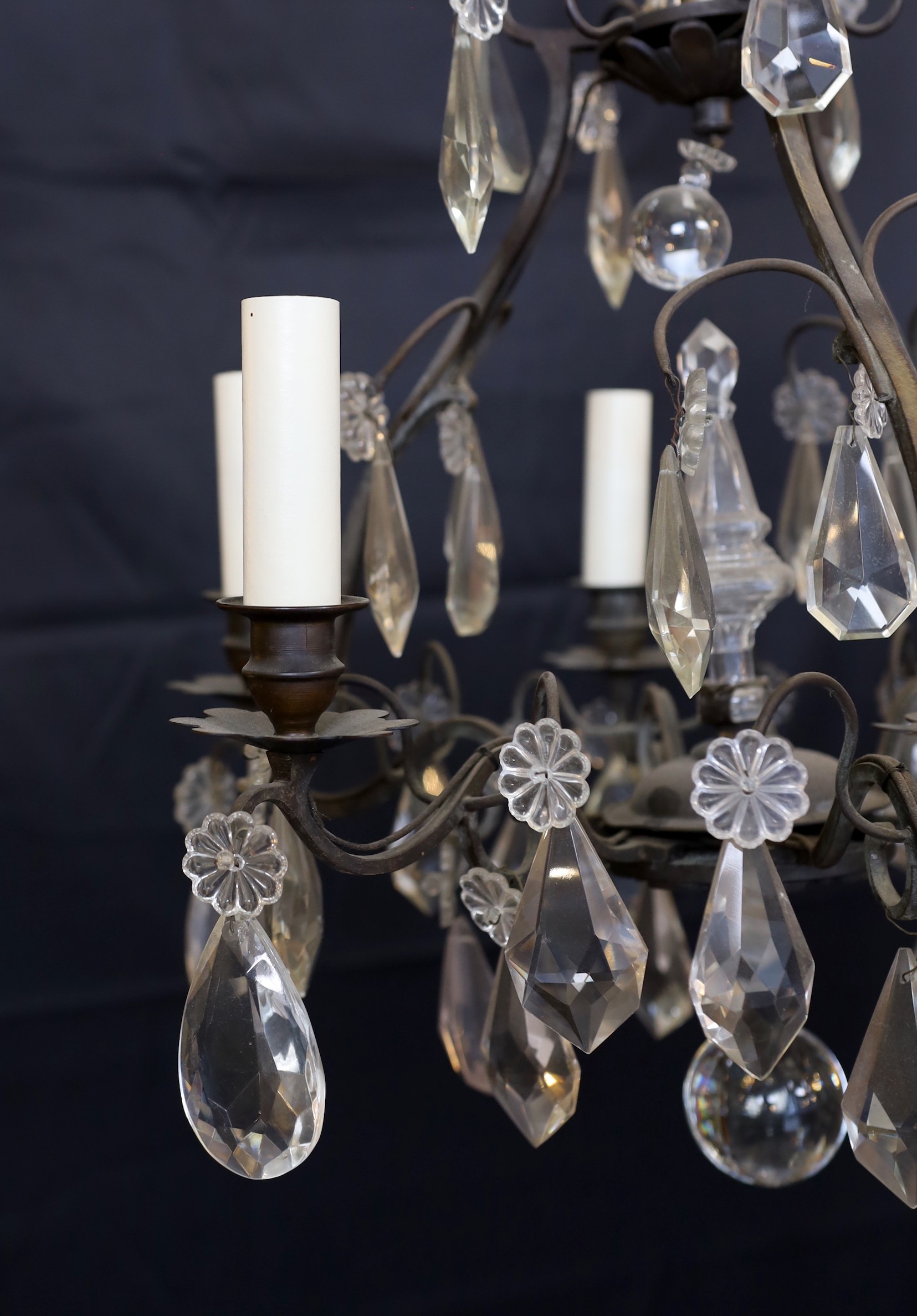 An early 20th century French bronze and cut glass six light chandelier hung with tear shaped and faceted drops, height 63cm. width 42cm